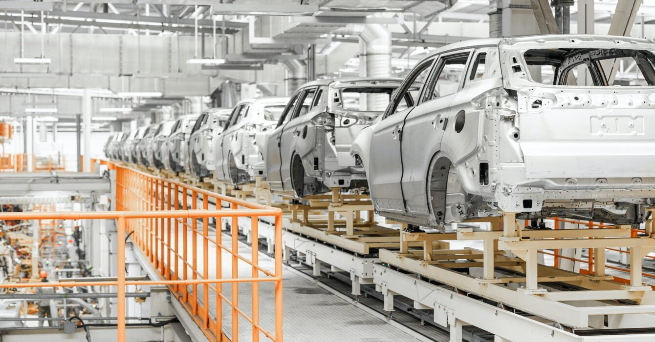 Photo of automobile production line. Welding car body. Modern car assembly plant. Auto industry