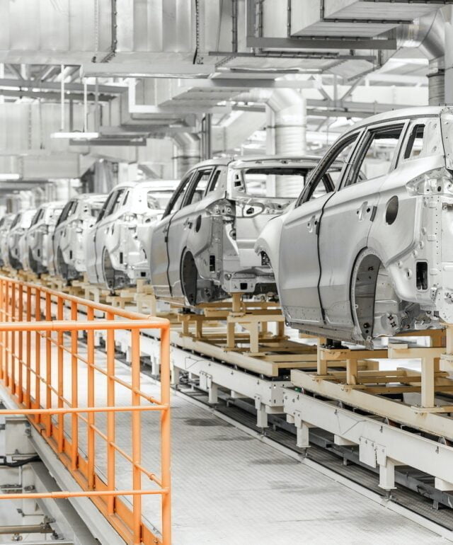 Photo of automobile production line. Welding car body. Modern car assembly plant. Auto industry