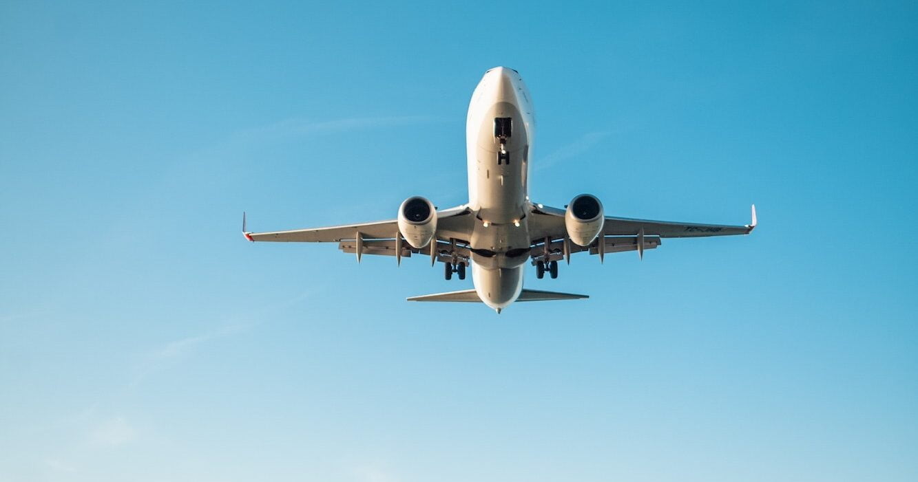 woman filming plane landing on phone